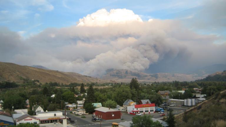 A cloud of wildfire smoke looms over a town in Washington's Methow Valley
