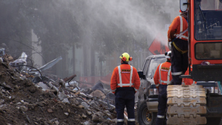 Workers survey earthquake damage