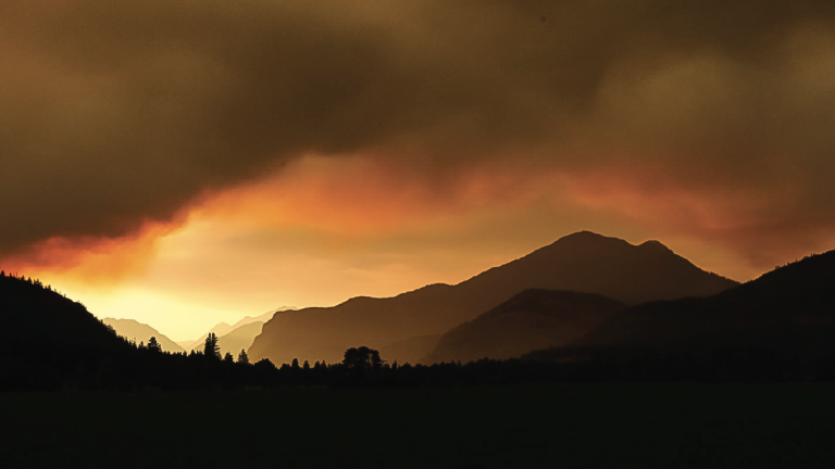 wildfire smoke seen above hllls