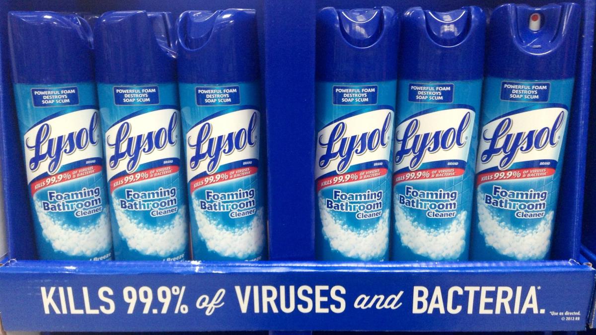Bottles of Lysol cleaning spray lined up on a shelf