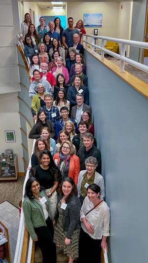 a crowd of people pose on the stairs for a photo